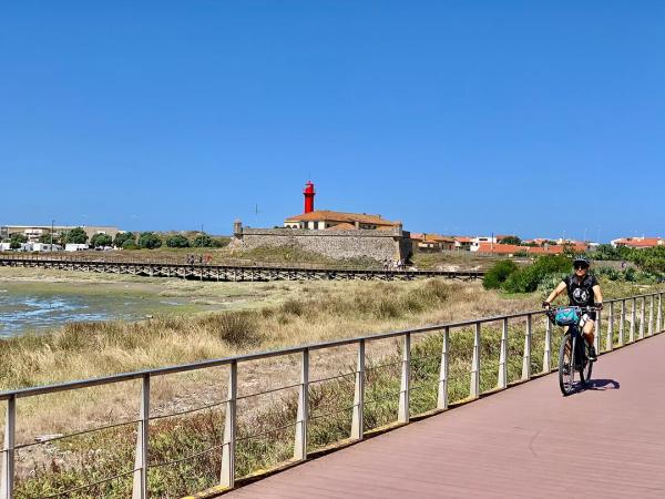 Cyclist in front of a lighthouse