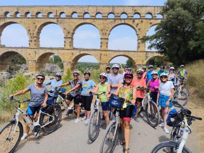 Happy cyclists in front of a huge viaduct