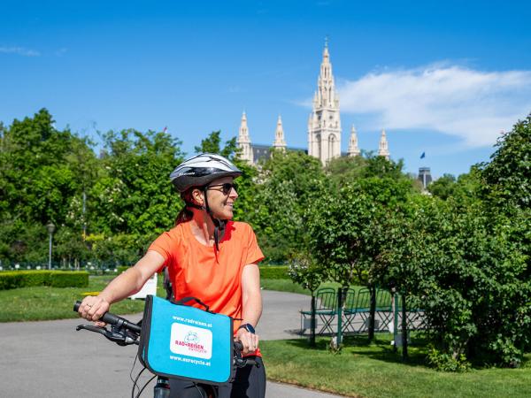 Cyclist in Vienna with city hall in background
