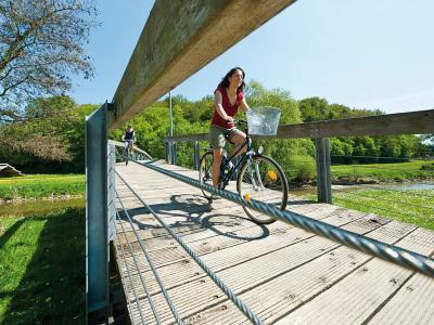 Treuchtlingen - Fahrradfahrer auf der Brücke im Kurpark