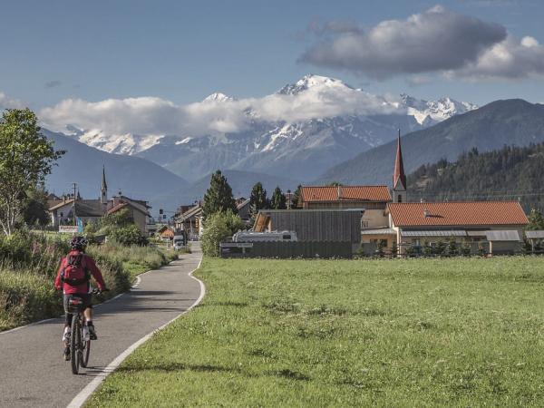 Cyclists along the way with alps in the background