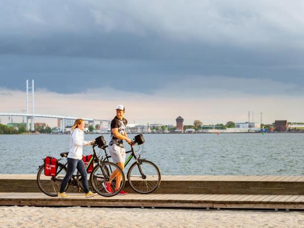 Cyclists in front of the bridge to Rügen