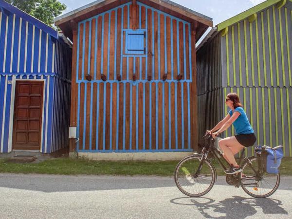 Colorful beach houses with cyclist