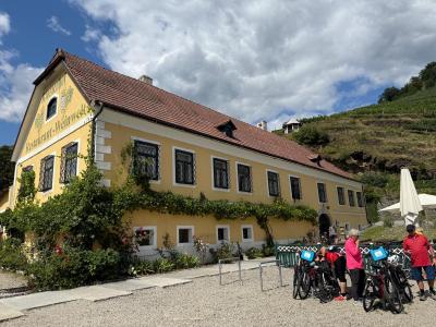 Cyclists in front of a winery in the Wachau Valley