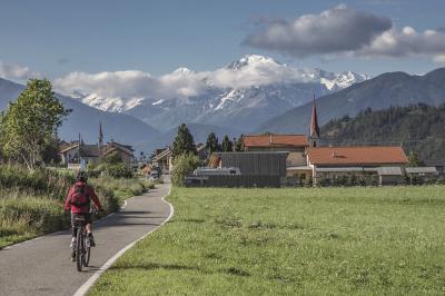 Cyclists along the way with alps in the background