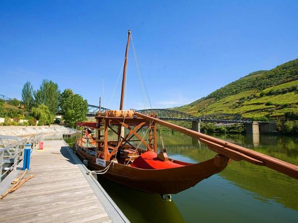 traditional wooden Rabelo boat docked at the bank of the douro river