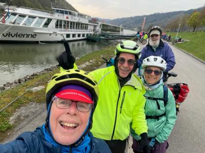 Cyclists in front of the vessel MS Vivienne laughing